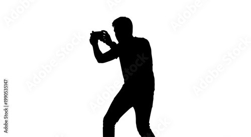 Silhouette of a person holding a camera and taking a photo.