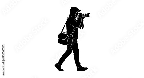 Silhouette of a photographer walking with camera and bag.