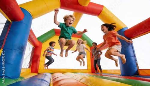 Inflatable bounce house with children jumping inside from diagonal angle with rich color