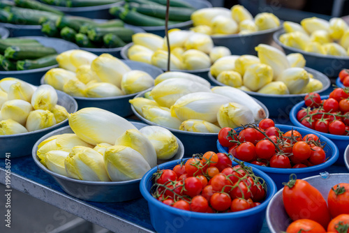 Tomatoes and various vegetables on a market stall