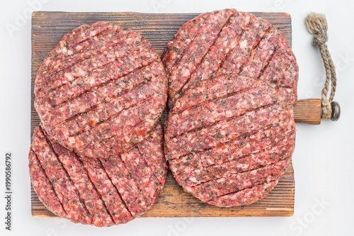 Raw mixed beef and lamb Hamburger patties with grill marks on isolated background with copy space.