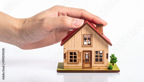 Hand Holding Wooden House Model
