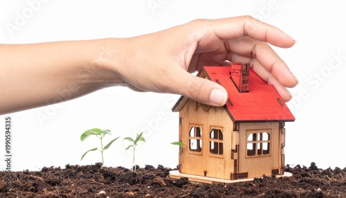 Hand Holding Wooden House Model