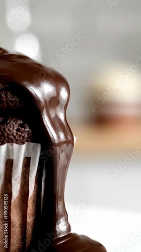 Close-up of delicious chocolate cupcake with chocolate ganache topping. Sweet dessert treat with rich flavor.