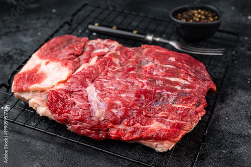 Photos Closeup of raw beef brisket meat showing marbling and texture, premium barbecue