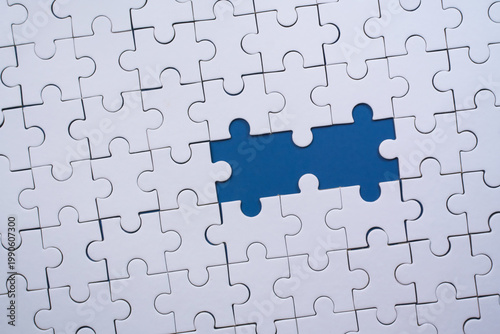 White puzzle pieces illustrate a problem-solving concept with missing parts.