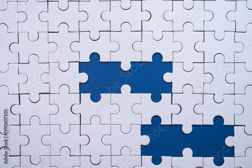 White jigsaw puzzle pieces showing missing blue background connections clearly