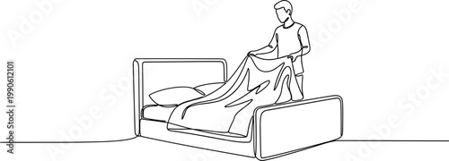 Man making bed in bedroom.