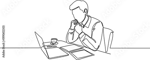 Man sitting at desk with laptop.