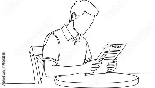 Man sitting at table reading newspaper.