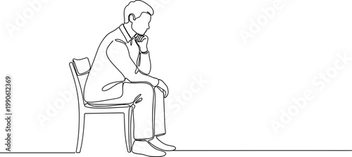 Man sitting on chair looking down.