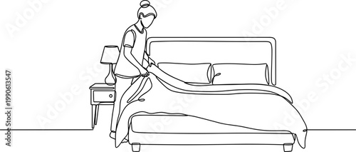 Woman making hotel bed linens.