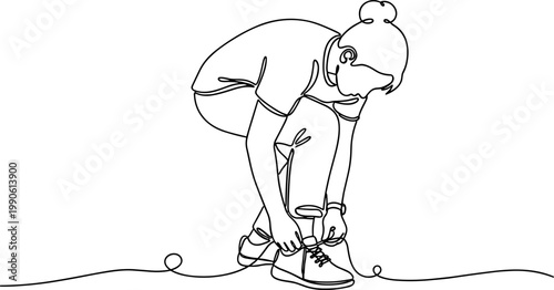 Woman tying her shoelace carefully outdoors.