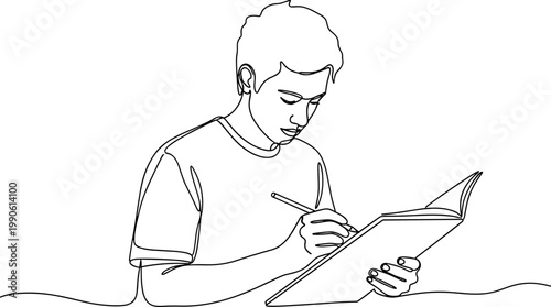Young man writing on notebook.