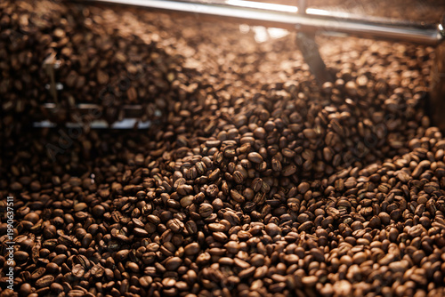 Bild auf Leinwand Warm lit Freshly aroma roasted coffee beans inside cooling drum with metal agita