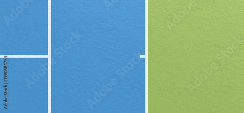 Side view of tennis court with blue and green surface divided by white boundary lines