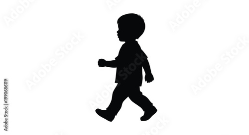 A young child is captured mid stride walking forward in a dark silhouette