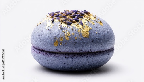 Delicate lavender macaron with edible gold leaf and floral garnish