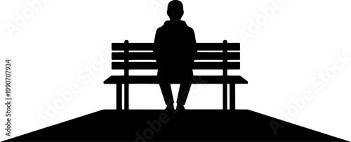 Silhouette of a person sitting alone on a park bench