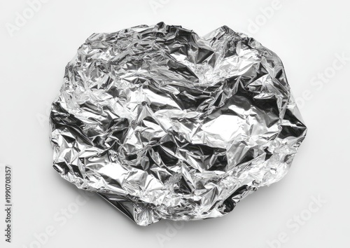 Crinkled metallic sheeting, reflecting light with sharp, angular creases on a white background