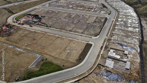 Overhead Aerial View of Brand New Residential Subdivision with Platted Lots and Road Infrastructure Under Early Construction