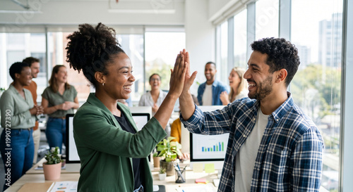 Happy Diverse Colleagues High Fiving in Modern Office