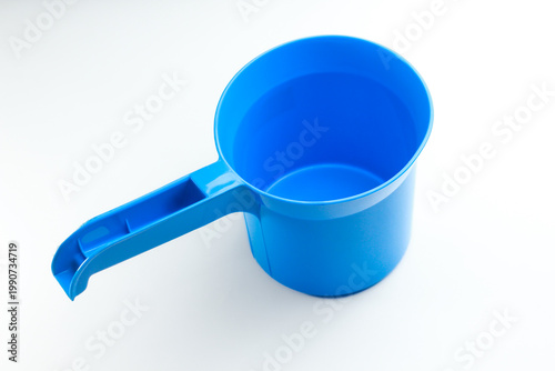 Blue plastic water dipper isolated on white background. Traditional bathroom scoop for water bailer
