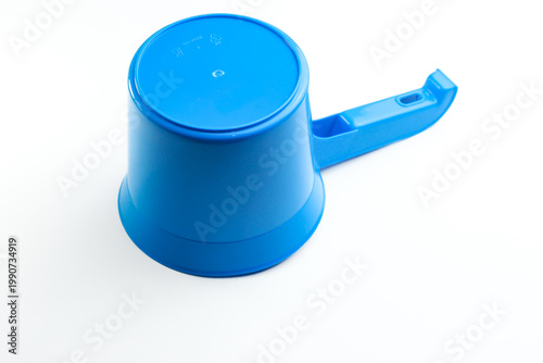 Blue plastic water dipper isolated on white background. Traditional bathroom scoop for water bailer