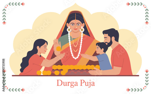 An Indian family offering marigold flowers to the goddess Durga idol during the Durga Puja festival celebration