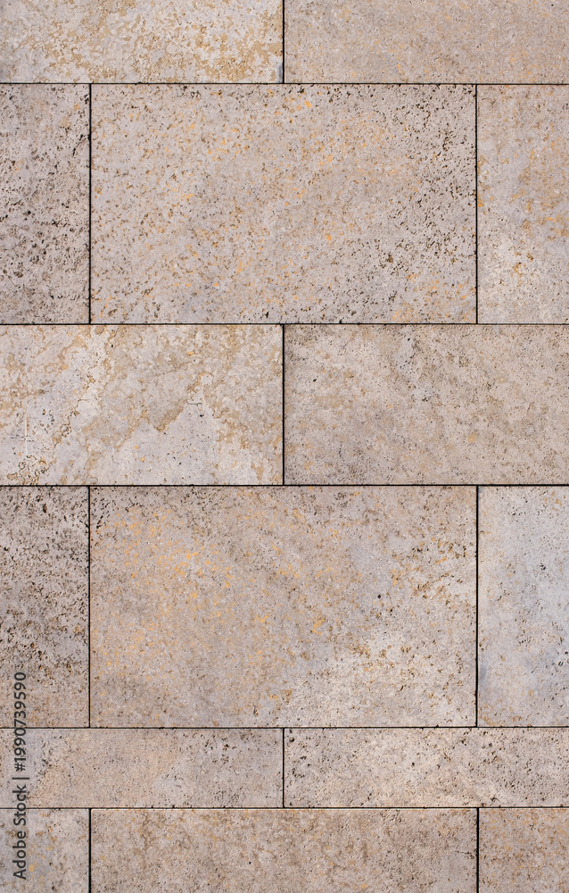 Fototapeta premium Natural stone tile wall facade with warm beige and orange mineral tones