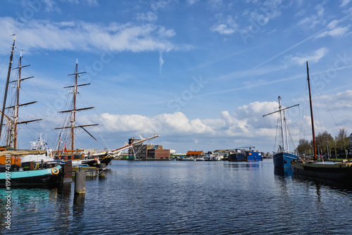 Fotografie Wide angle view of traditional sailing ships and historic vessels moored in a ha