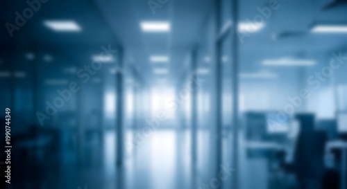 Blurred interior scene a modern office or commercial space with glass partitions and soft lighting