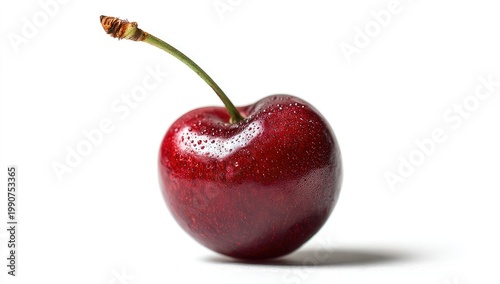 Single glossy dark red cherry with stem, water droplets, casting shadow on white