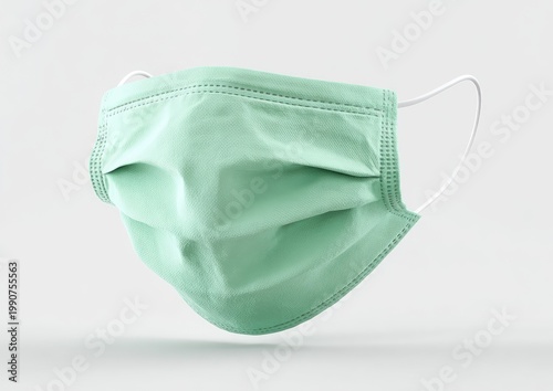 A soft, pleated green medical face mask with white ear loops