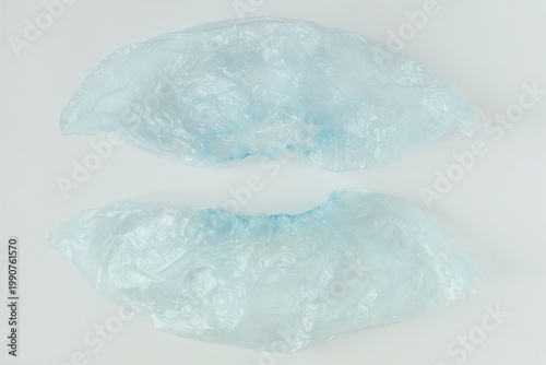 Blue medical shoe covers. White background.