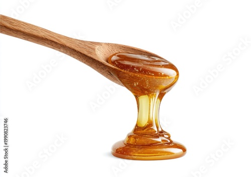 Viscous golden liquid dripping from a wooden spoon in a close-up shot