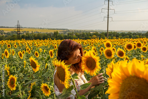 Fotografie portrait of a dark-haired woman in a summer sundress against the background of a