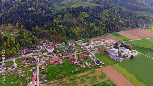 aerial village with forest and farmland