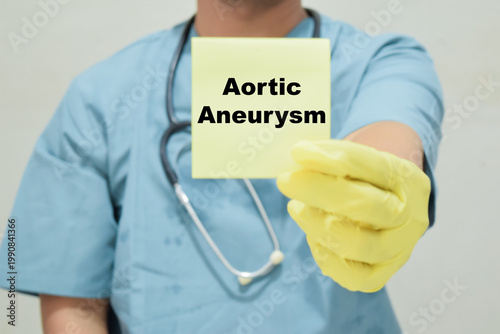 Doctor holds in hands a card with the name of the aortic aneurysm. Medical concept