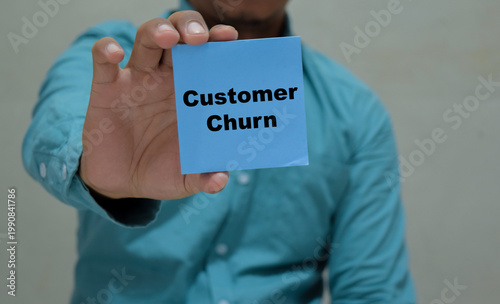 Businessman holds in hands a card with the name of the customer churn.