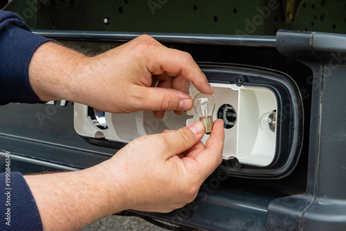 Changing light bulb in truck rear lamp