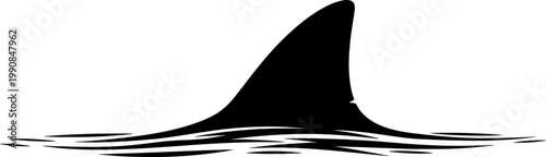 Great white shark fin silhouette breaking the water surface