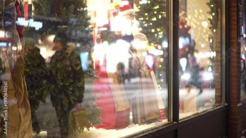Festive holiday window display with lights and decorations at night  