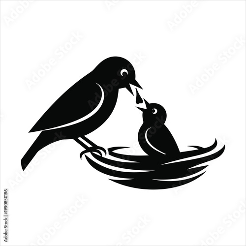 Bird silhouette feeding a baby bird in the nest wildlife concept