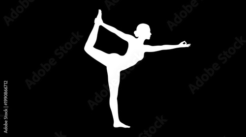 A woman performs a yoga pose in a studio with a black background.