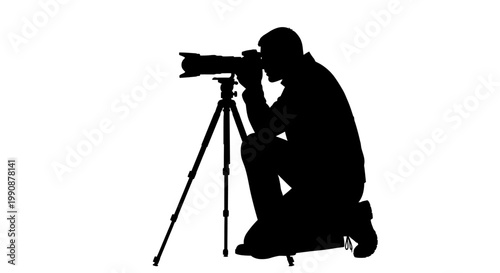 Photographer kneeling with camera on tripod dramatic black silhouette