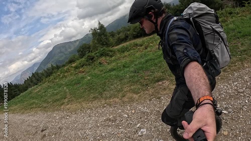 Man Riding Unicycle On Mountain Trail In Slow Motion Side View