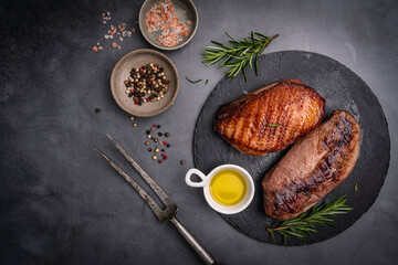 Roasted or grilled duck breast with the addition of aromatic herbs , top view. Food recipe background. Close up. High quality photo