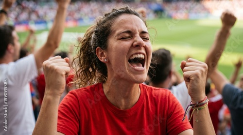 A female football fan celebrating a goal in the stadium. Concept of support and passion for the sport.