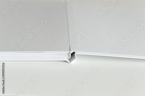 Open hardcover book mockup with blank pages and visible binding minimal publishing and printing concept